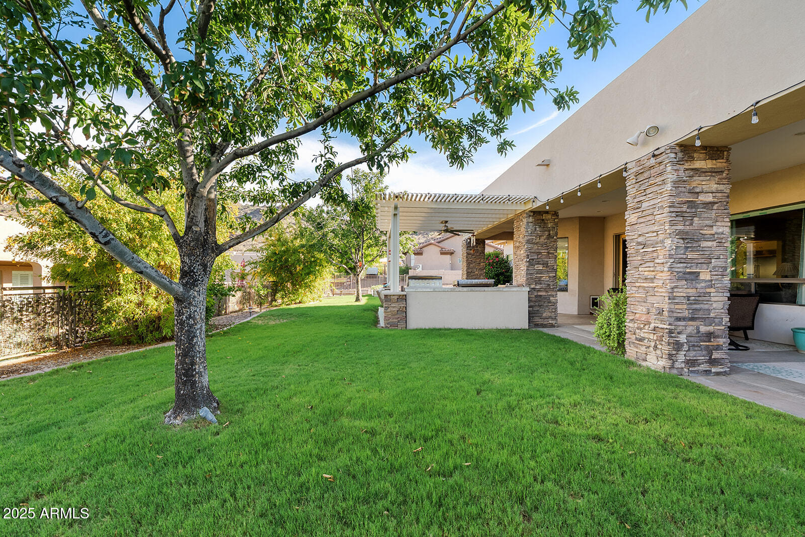 8705 South 24th Place Phoenix, AZ 85042 - Photo 40 of 43 a view of a white house with a big yard and large trees