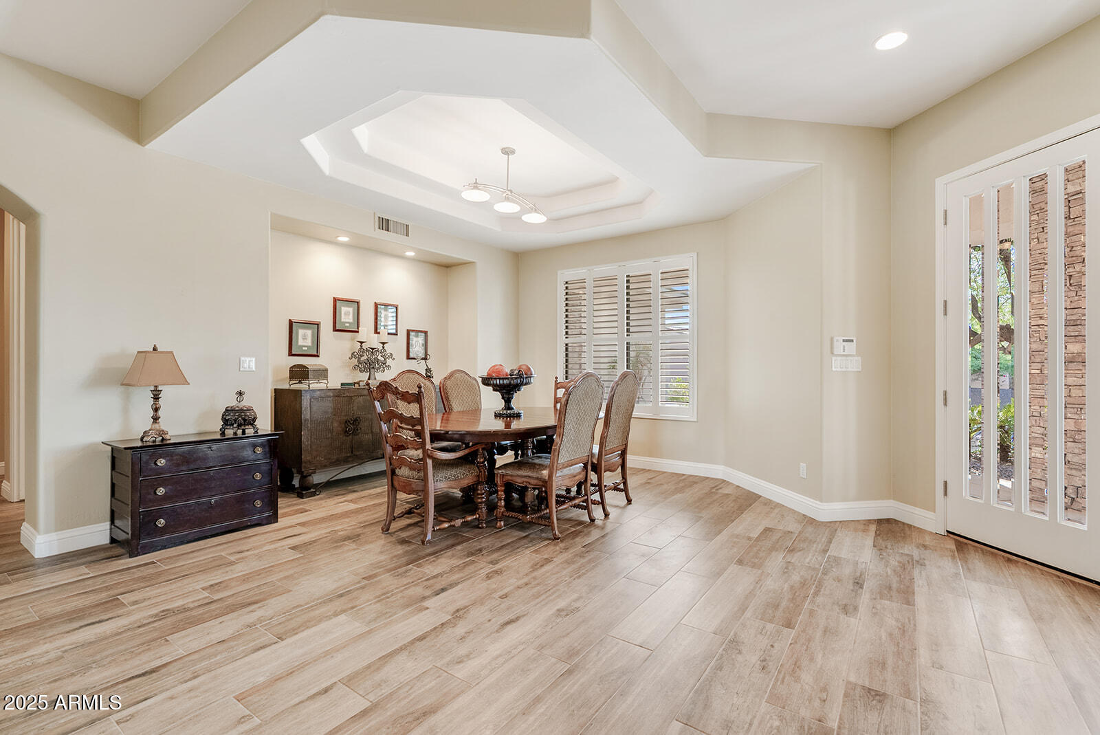 8705 South 24th Place Phoenix, AZ 85042 - Photo 8 of 43 a view of a dining room with furniture and wooden floor