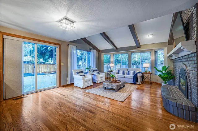 a living room with fireplace furniture and a flat screen tv