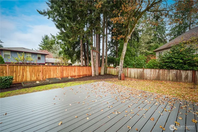 a view of backyard with wooden fence