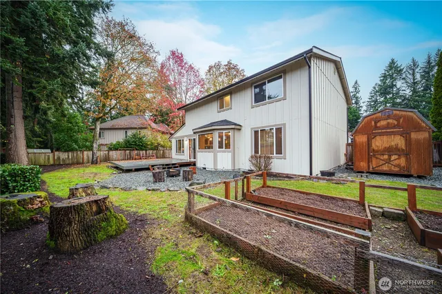 a view of a house with backyard and swimming pool