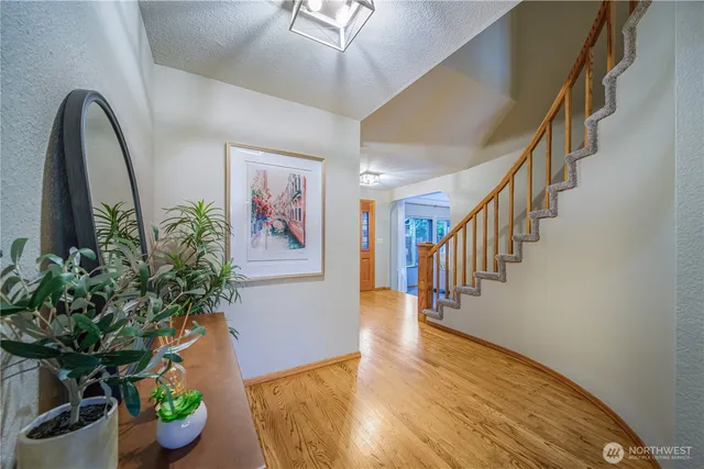 a hallway with a potted plant on the wall
