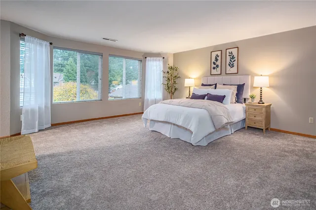 a spacious bedroom with a bed and a couch