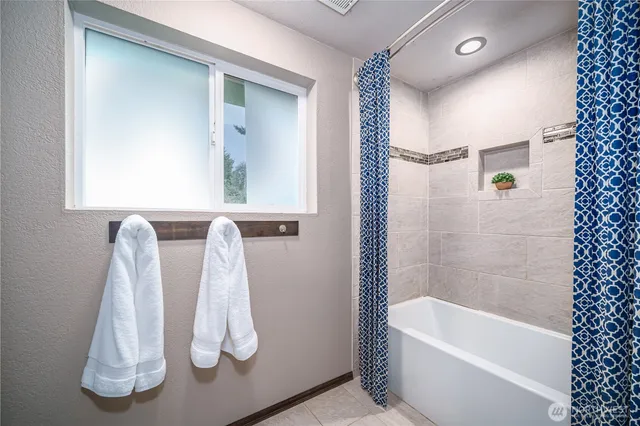 a bed sitting in a bedroom next to a lamp