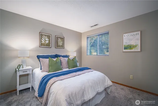 a bedroom with a bed and a lamp