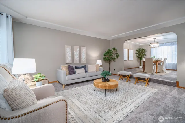 a living room with furniture and a potted plant