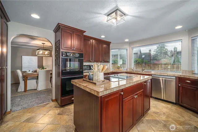 a kitchen with granite countertop counter space a sink appliances and cabinets