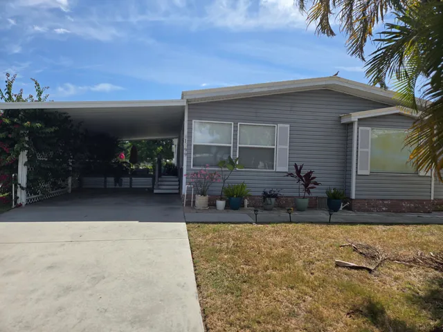 a house with potted plants in front of it