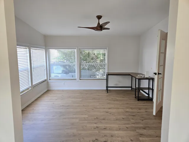 wooden floor in an empty room with a window