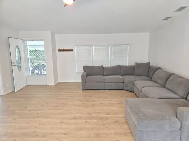 a living room with furniture and a ceiling fan