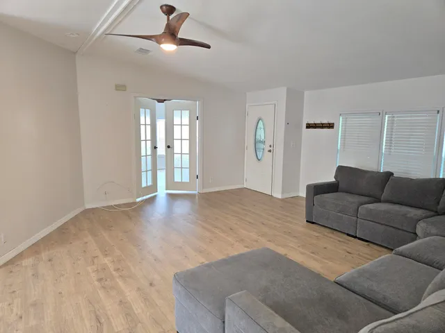 a living room with furniture and wooden floor