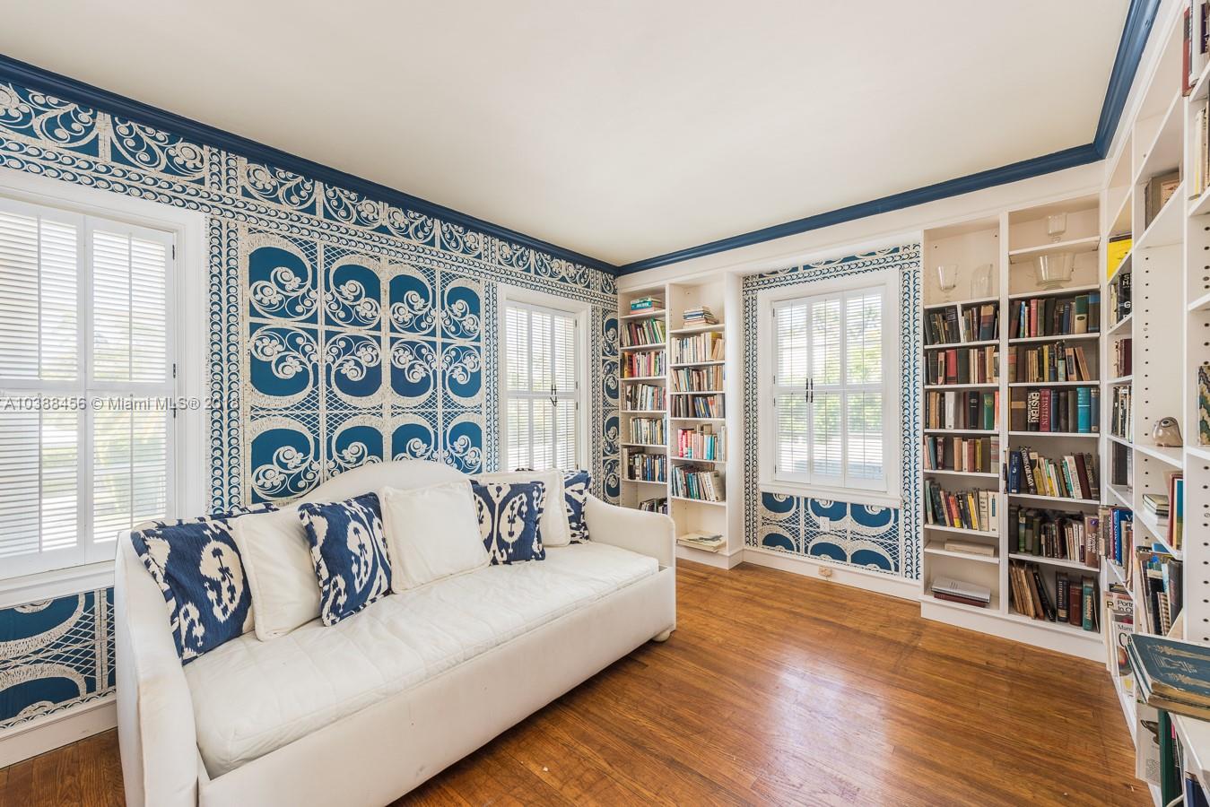 6645 Pine Tree Lane Miami Beach, FL 33141 - Photo 13 of 21 a living room with furniture and a floor to ceiling window