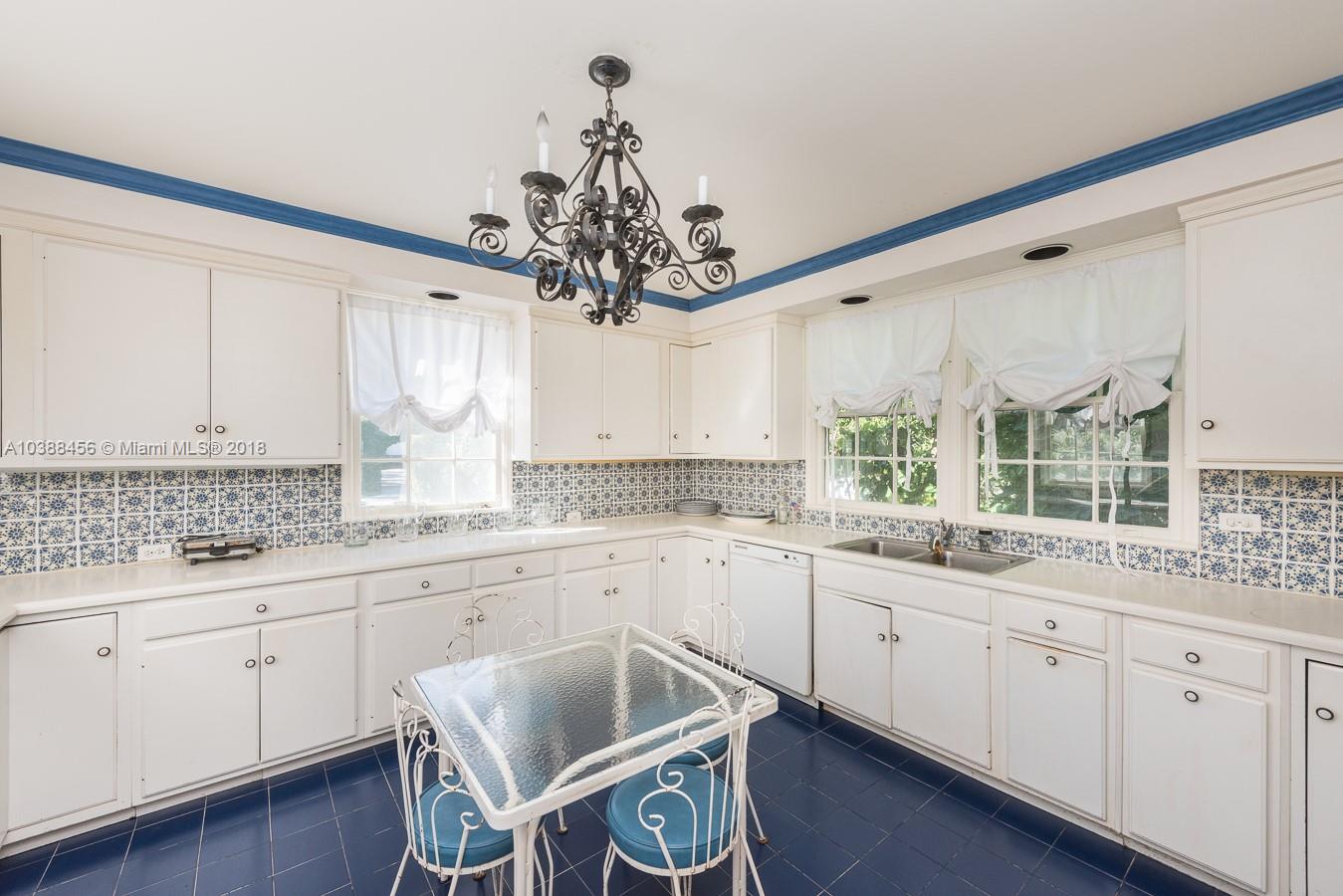 6645 Pine Tree Lane Miami Beach, FL 33141 - Photo 15 of 21 a kitchen with a sink cabinets and window