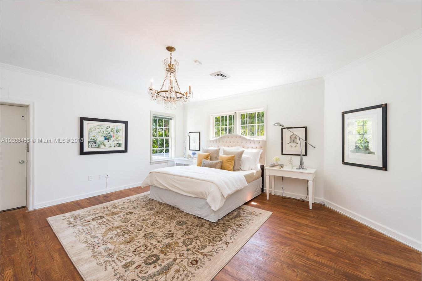 6645 Pine Tree Lane Miami Beach, FL 33141 - Photo 8 of 21 a spacious bedroom with a bed and a large window