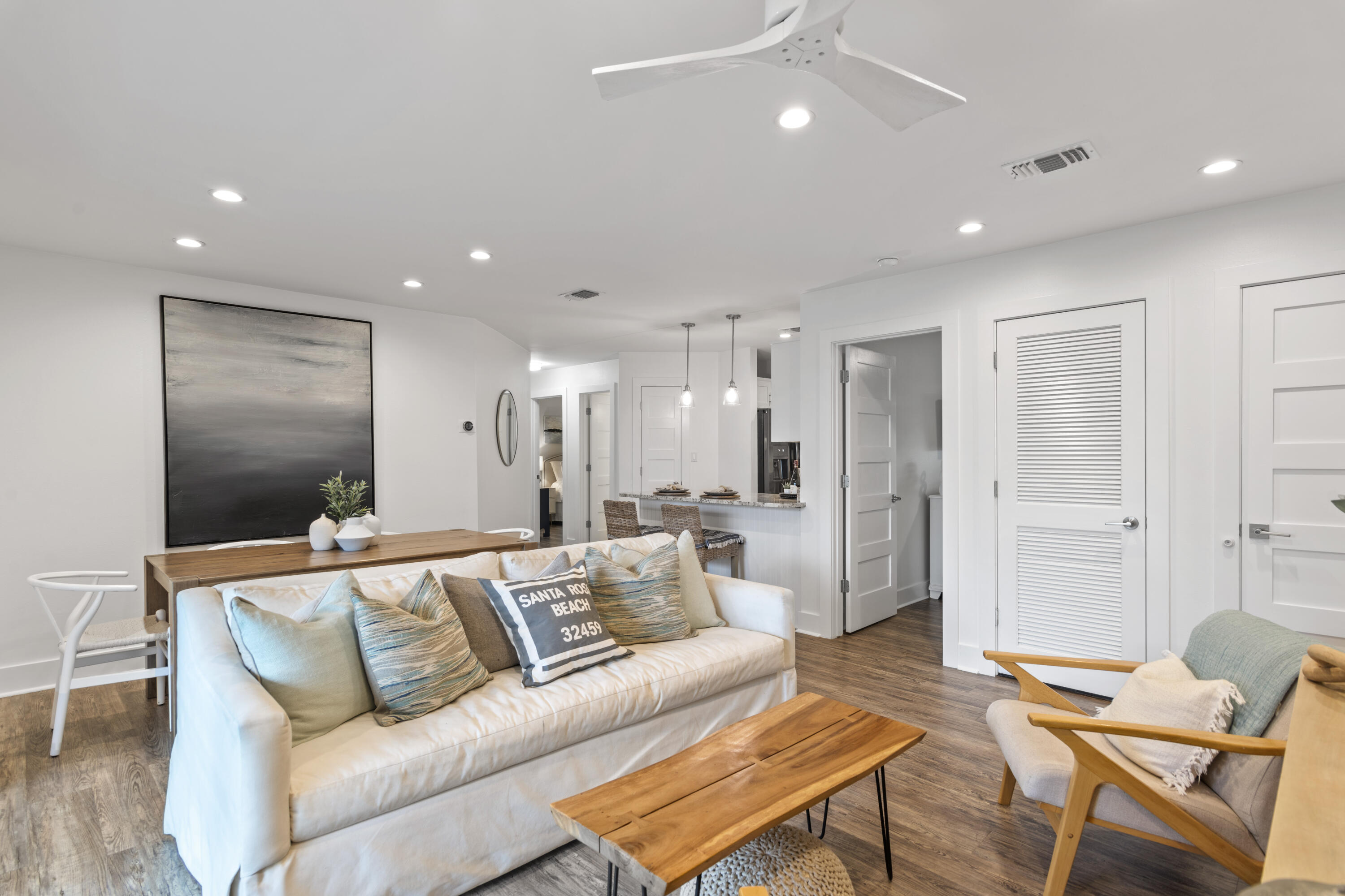 3799 East County Highway 30A, Unit F13 Santa Rosa Beach, FL 32459 - Photo 2 of 30 a living room with furniture and a dining table with kitchen view
