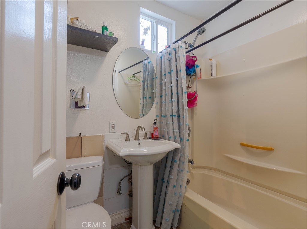 1211 Hoffman Avenue Long Beach, CA 90813 - Photo 15 of 33 a bathroom with a sink mirror vanity and toilet