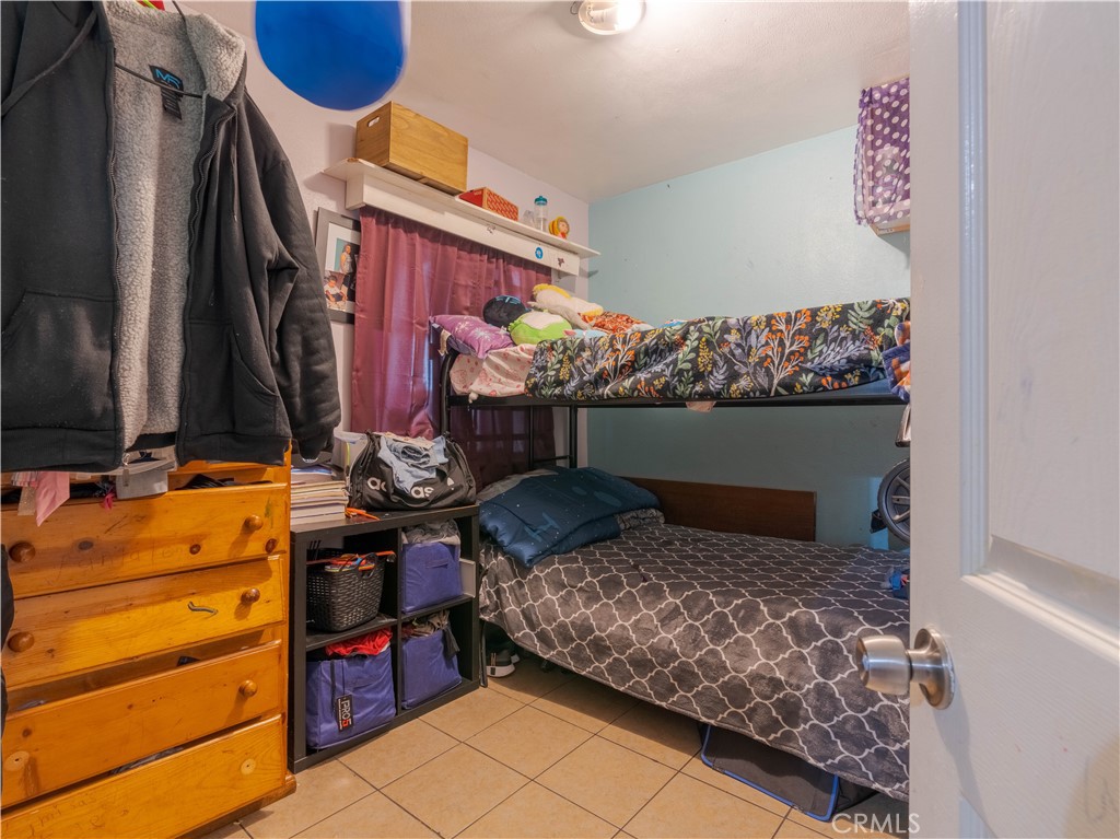 1211 Hoffman Avenue Long Beach, CA 90813 - Photo 17 of 33 a bedroom with a bed and a dresser in it