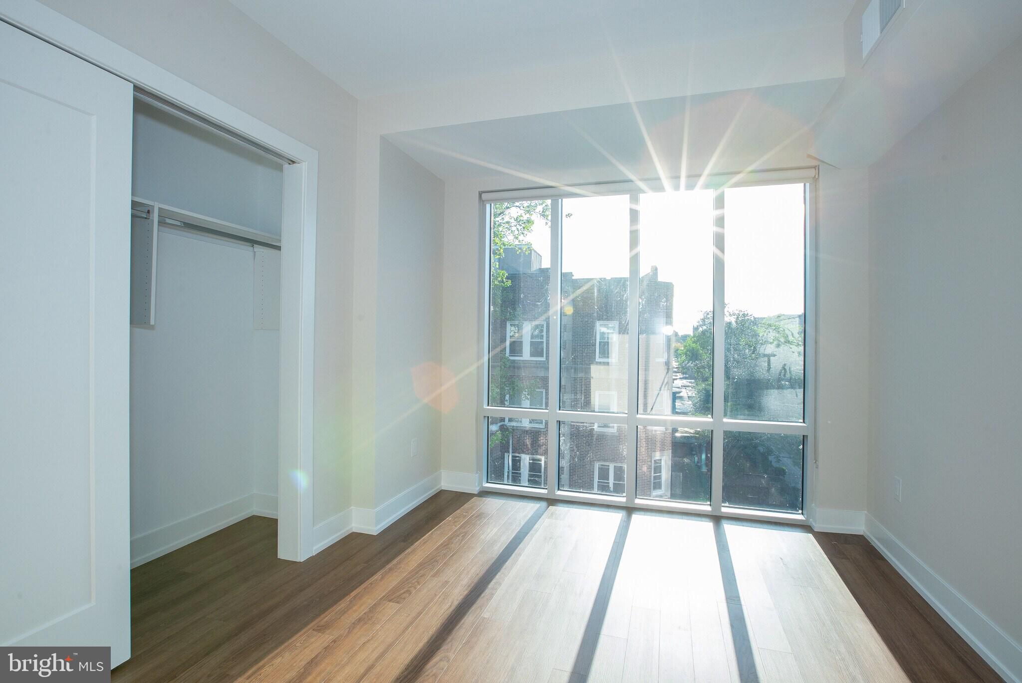 4534 Spruce Street, Unit 1BB4 Philadelphia, PA 19139 - Photo 4 of 9 a view of a room with wooden floor and balcony