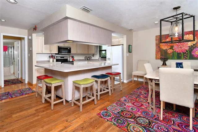 a view of a dining room with furniture and a wooden floor