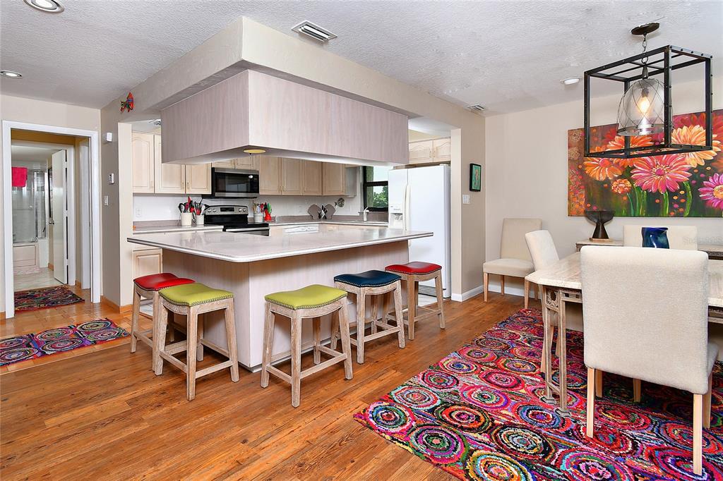 2 Pirates Lane, Unit 21C Punta Gorda, FL 33955 - Photo 12 of 36 a view of a dining room with furniture and a wooden floor