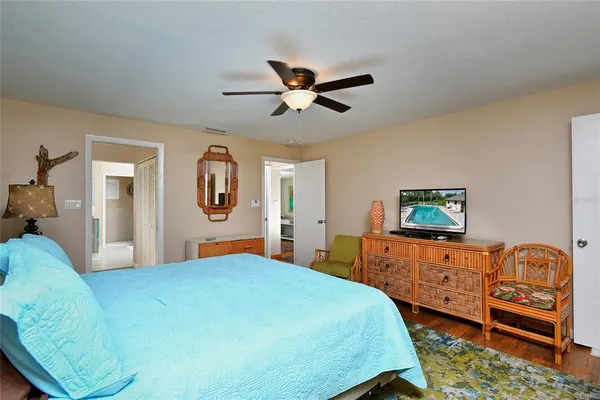 a bedroom with a bed and wooden floor