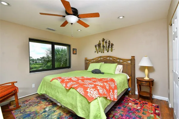 a bedroom with a bed and a painting on the wall