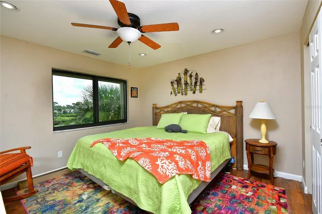 a bedroom with a bed and a painting on the wall