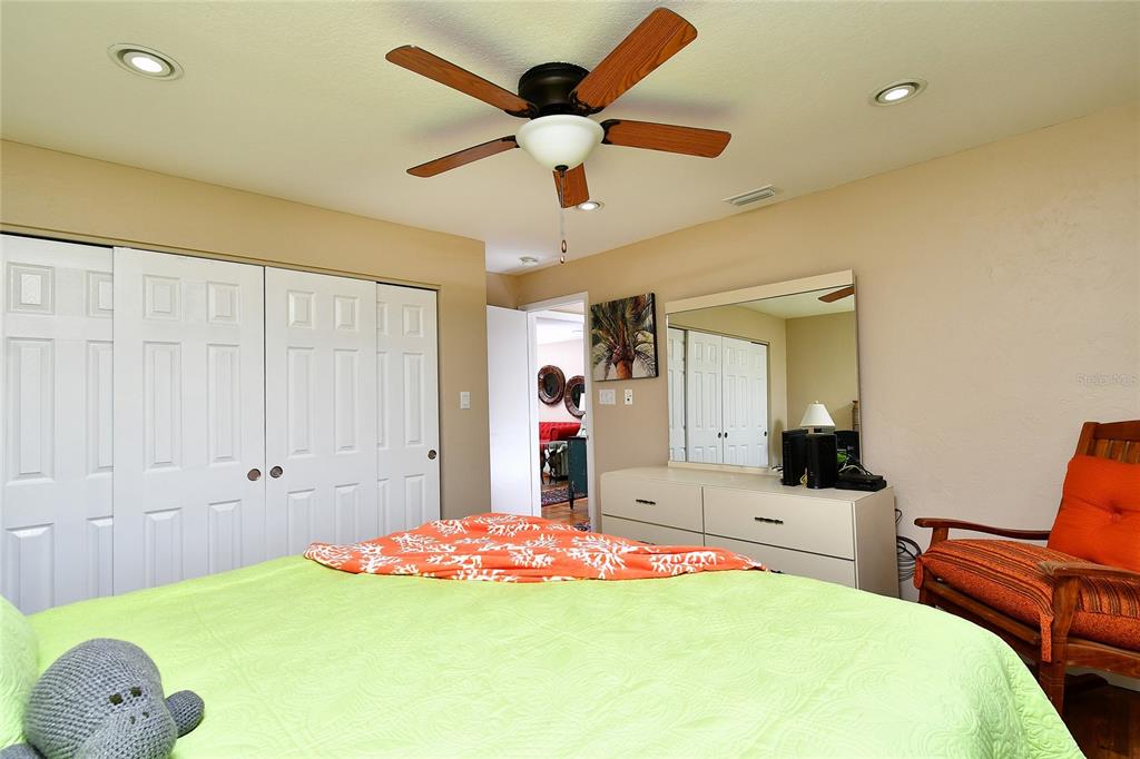 2 Pirates Lane, Unit 21C Punta Gorda, FL 33955 - Photo 25 of 36 a bed room with a bed and a chandelier