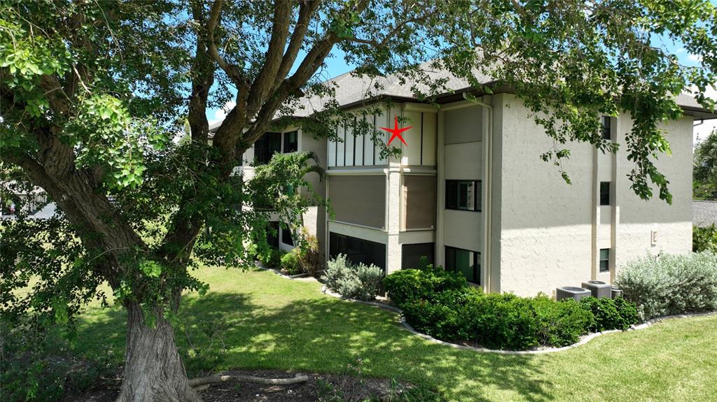 2 Pirates Lane, Unit 21C Punta Gorda, FL 33955 - Photo 27 of 36 a front view of a house with a garden