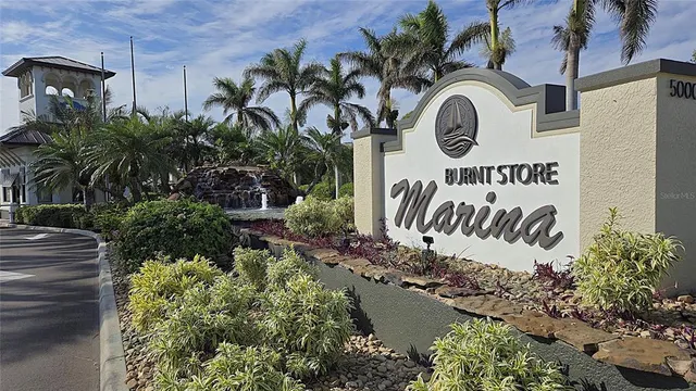 a sign that is on a wall next to a road