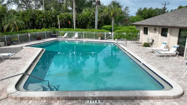 a view of a backyard with swimming pool