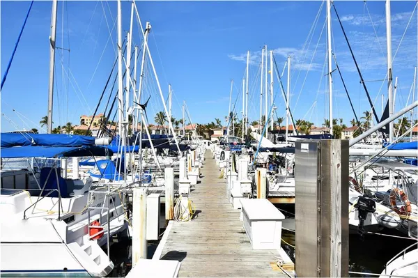 a view of a lake with boats next to yard