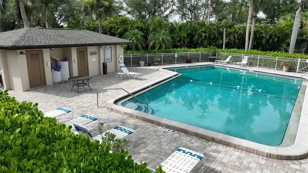a view of a backyard with swimming pool