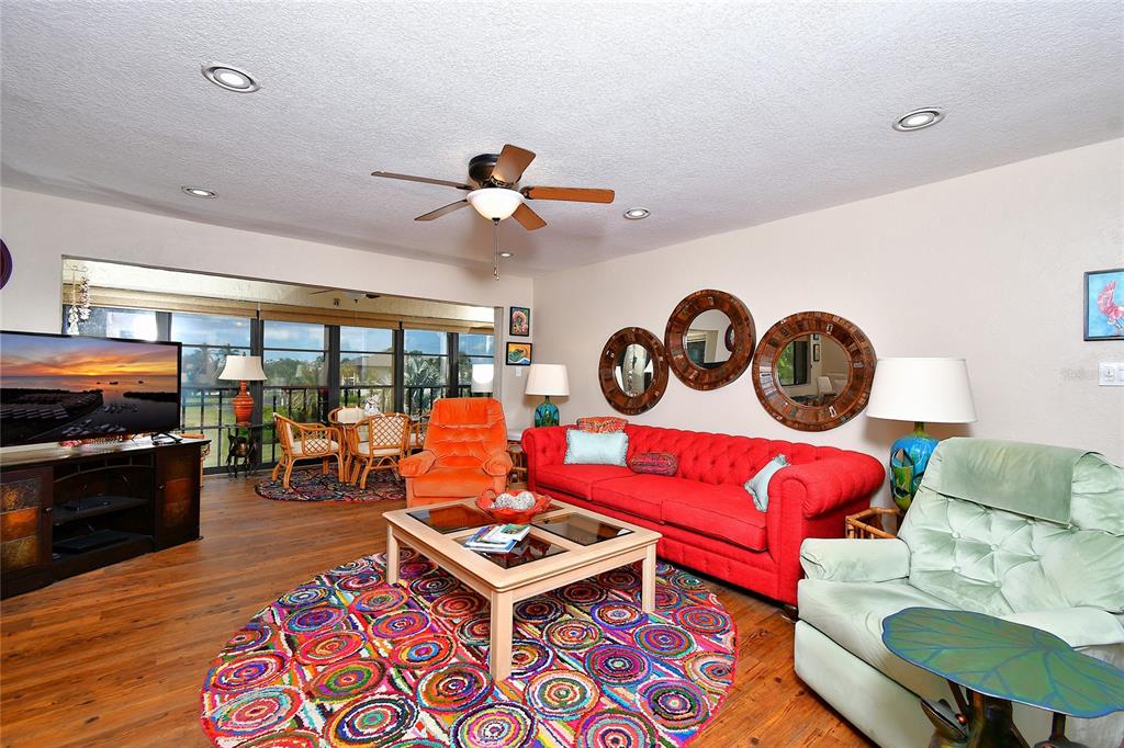 2 Pirates Lane, Unit 21C Punta Gorda, FL 33955 - Photo 8 of 36 a living room with furniture a rug and a floor to ceiling window