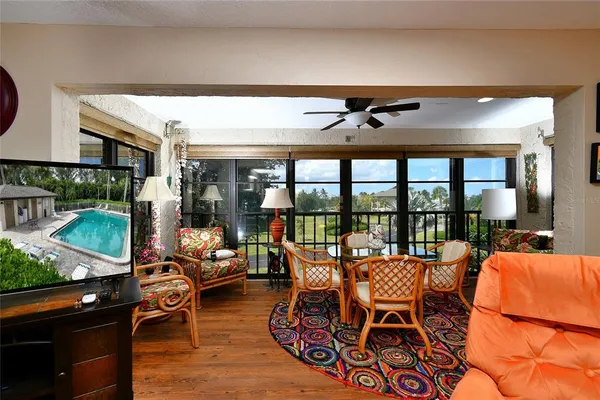a dining room with furniture and a floor to ceiling window