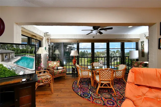a dining room with furniture and a floor to ceiling window
