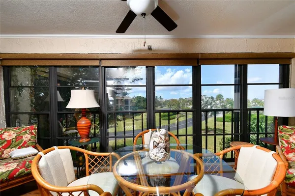 a dining room with furniture a rug and a large window