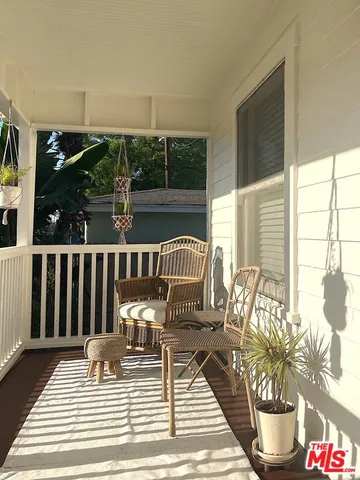 a view of a chair and tables back yard of the house
