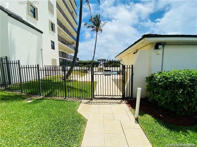 a view of a balcony with wooden floor and outdoor seating