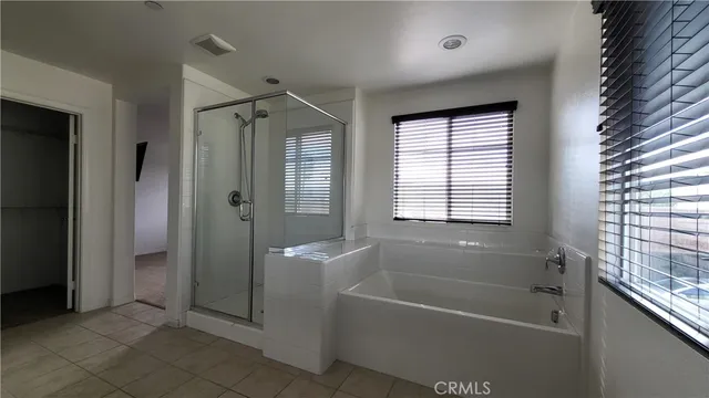 a bathroom with a bathtub and shower