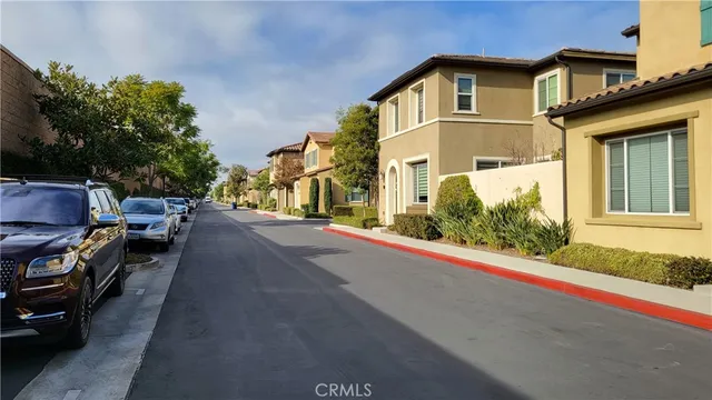 a view of a street with cars parked