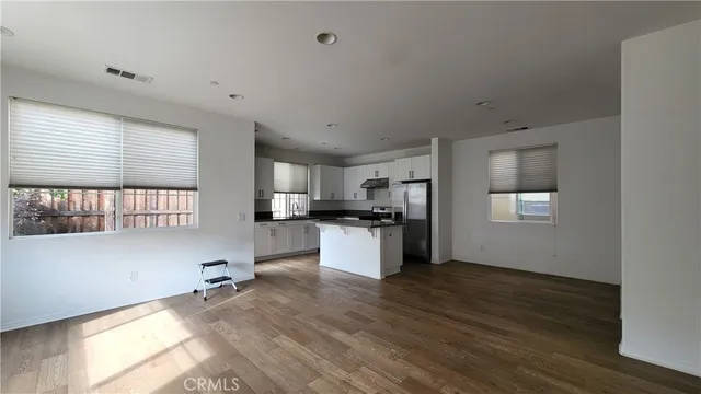 a kitchen with a refrigerator and a stove top oven
