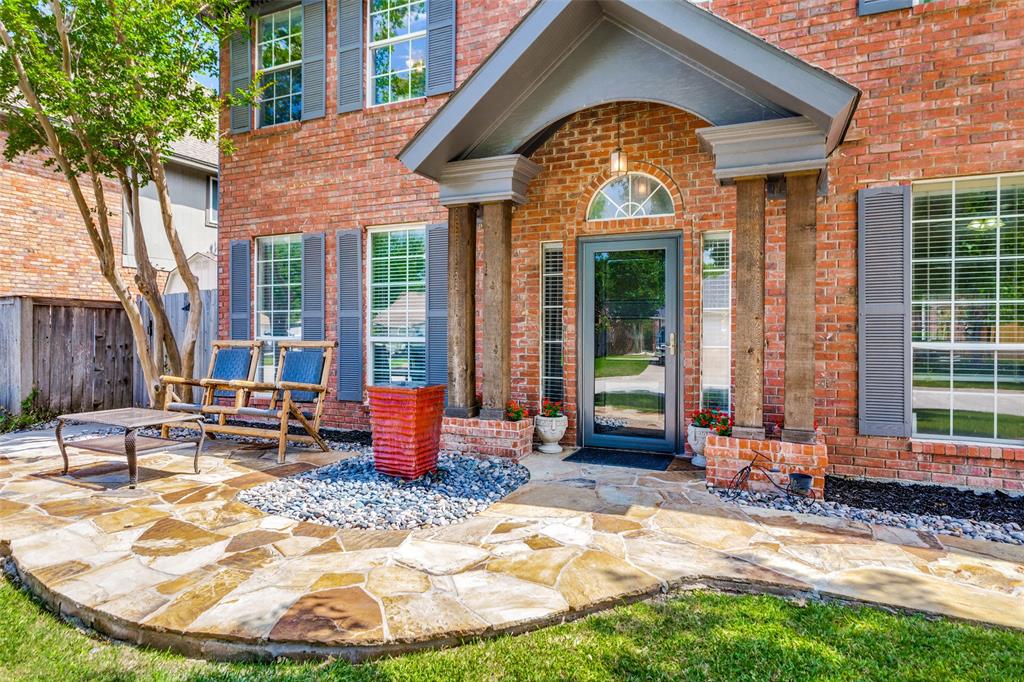 1228 Concho Drive Benbrook, TX 76126 - Photo 4 of 39 Brick facade featuring a covered entry, decorative arched transom, and fluted columns