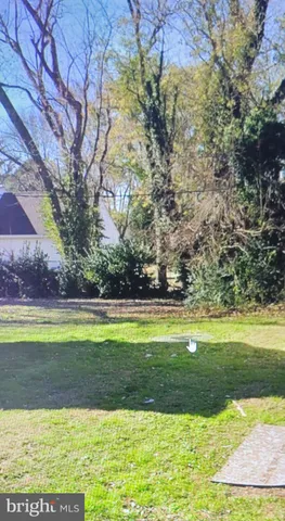 a view of a swimming pool with a yard