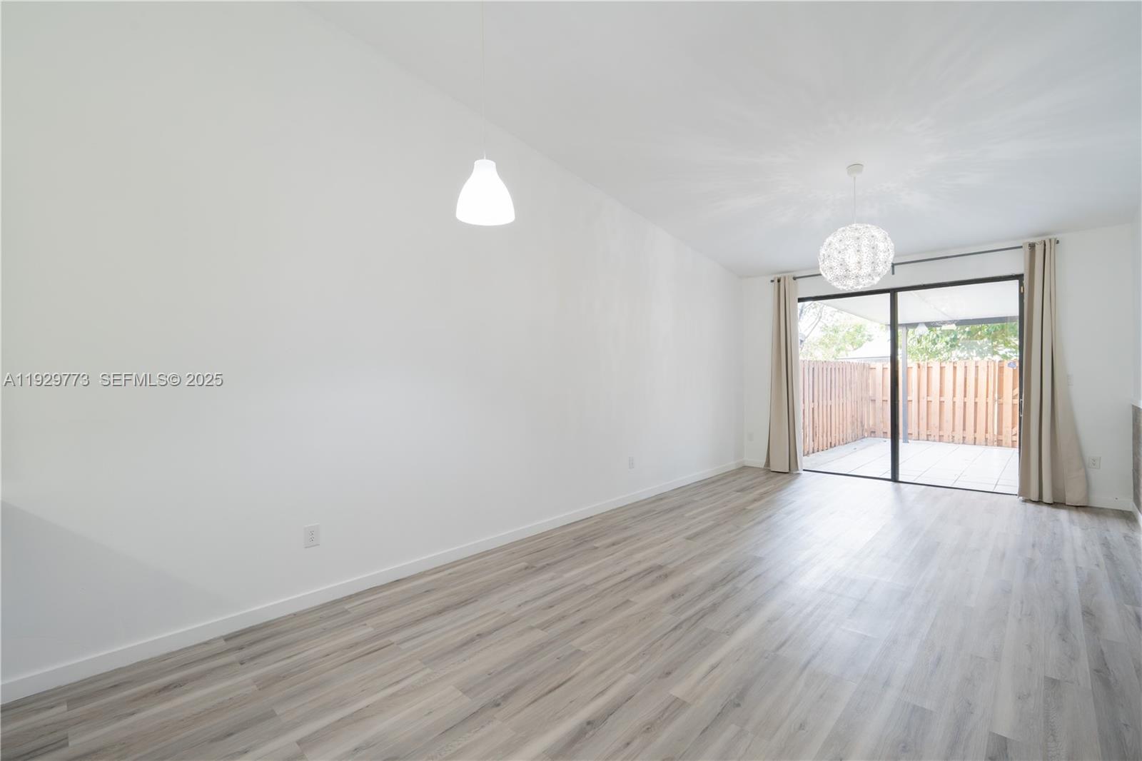 6725 Northwest 192nd Lane Hialeah, FL 33015 - Photo 15 of 29 a view of an empty room with wooden floor and a window