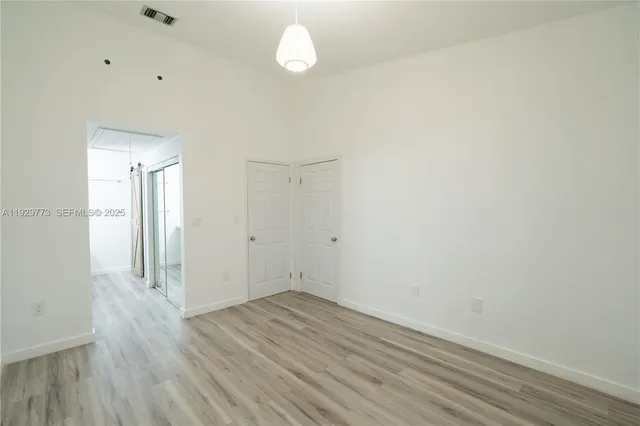 a view of a room with wooden floor