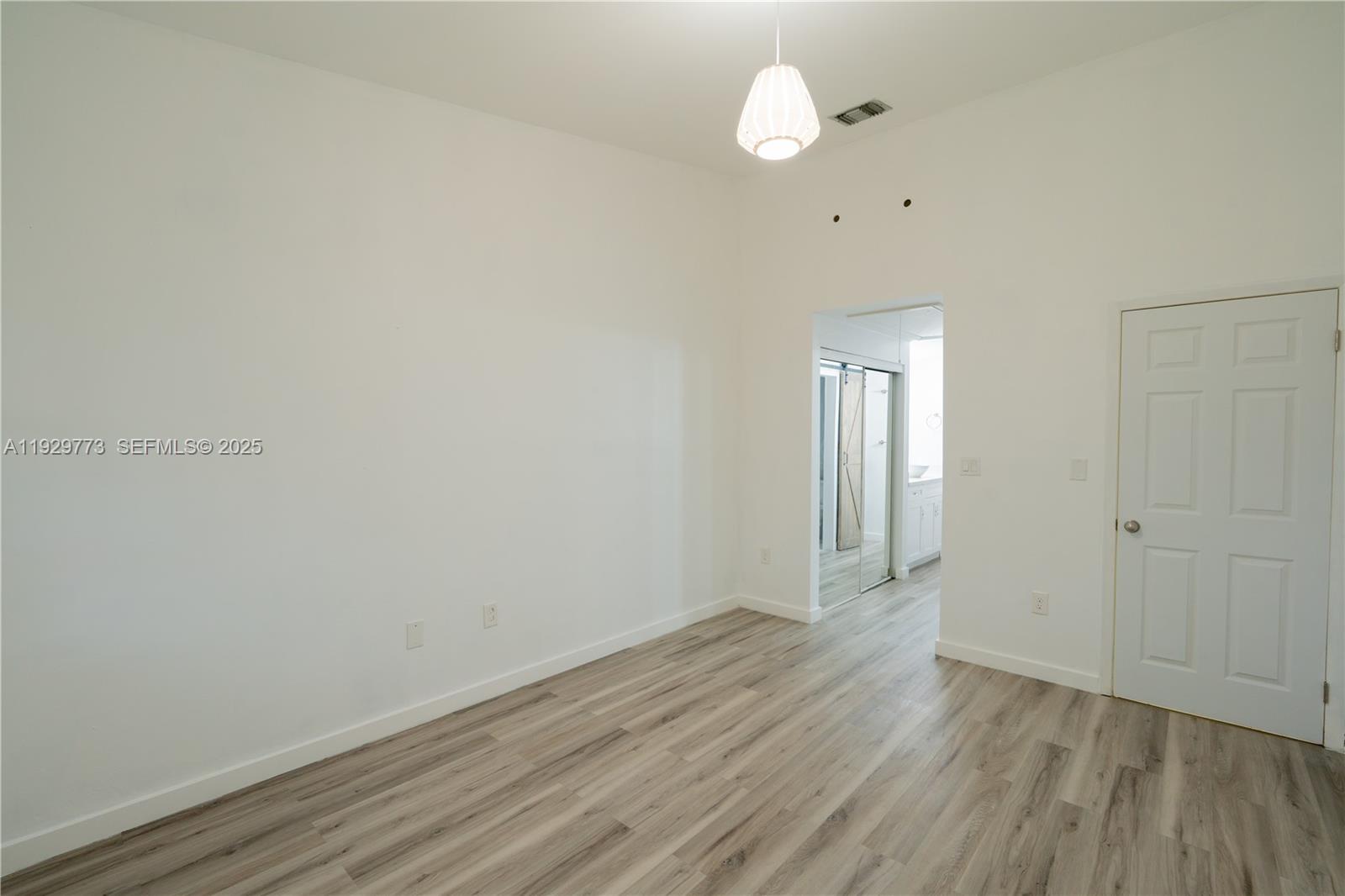 6725 Northwest 192nd Lane Hialeah, FL 33015 - Photo 20 of 29 a view of a room with wooden floor and a window