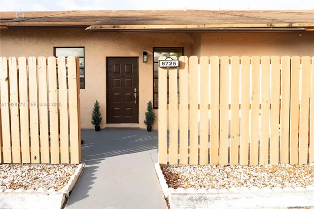 a view of a livingroom with wooden floor and a chair