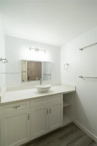 a bathroom with a sink and mirror