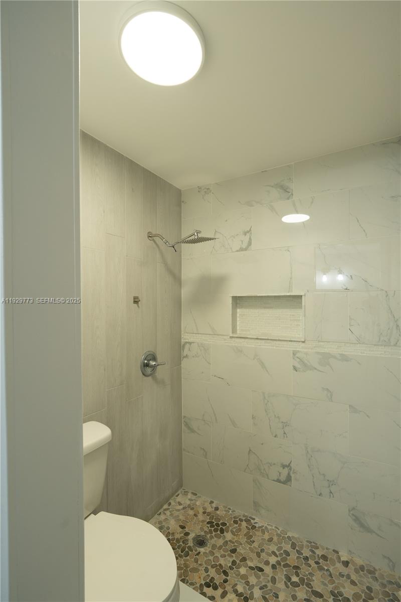 6725 Northwest 192nd Lane Hialeah, FL 33015 - Photo 23 of 29 a bathroom with a toilet and a shower